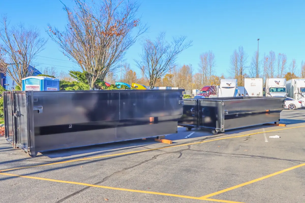 Professional dumpster rental service with roll-off container on residential driveway in West Brandywine